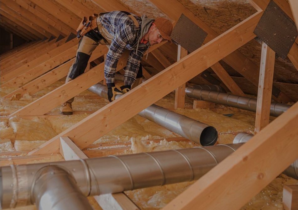 A Construction Worker Working on an Attic
